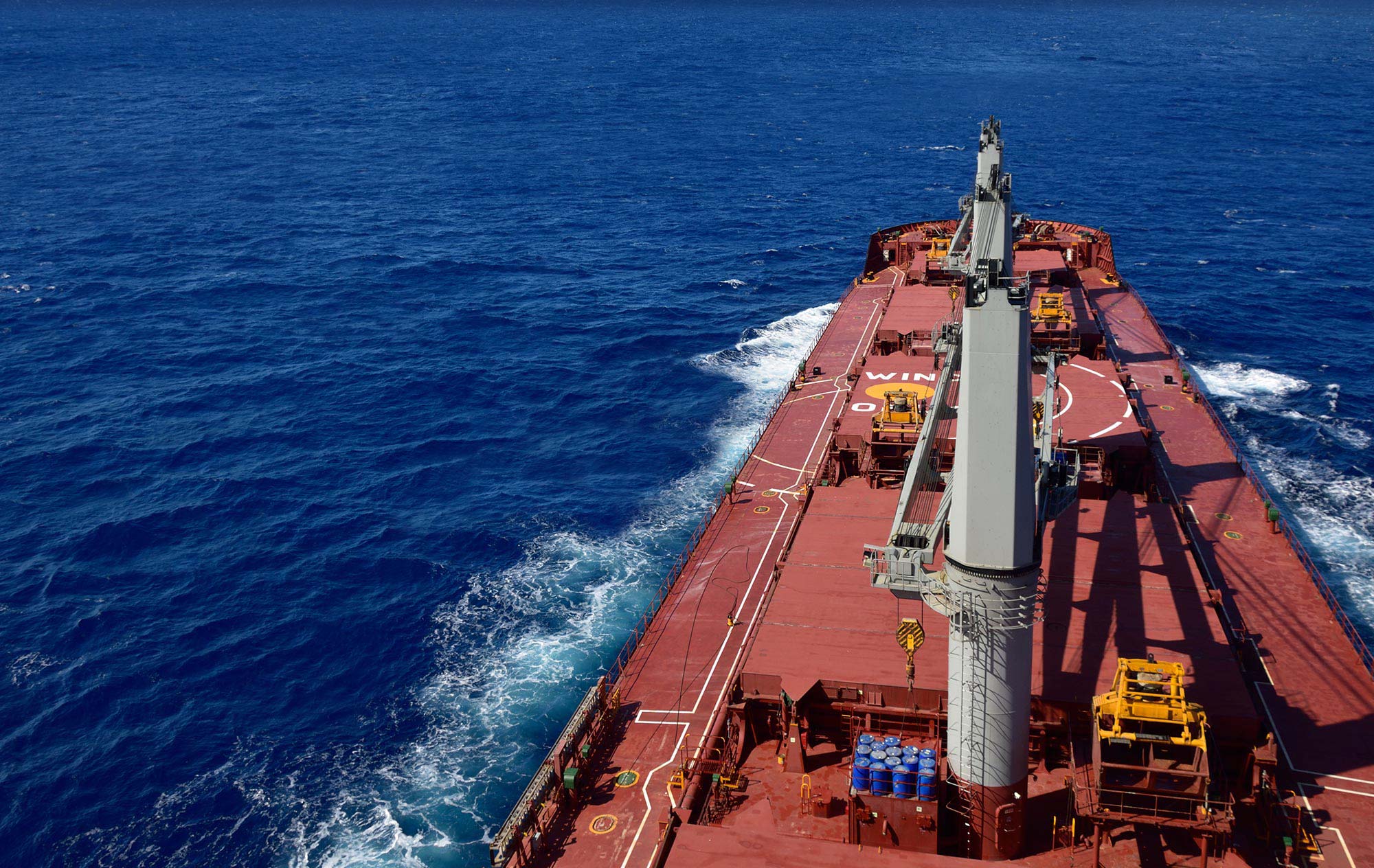 Large marine barge traversing through the ope blue water